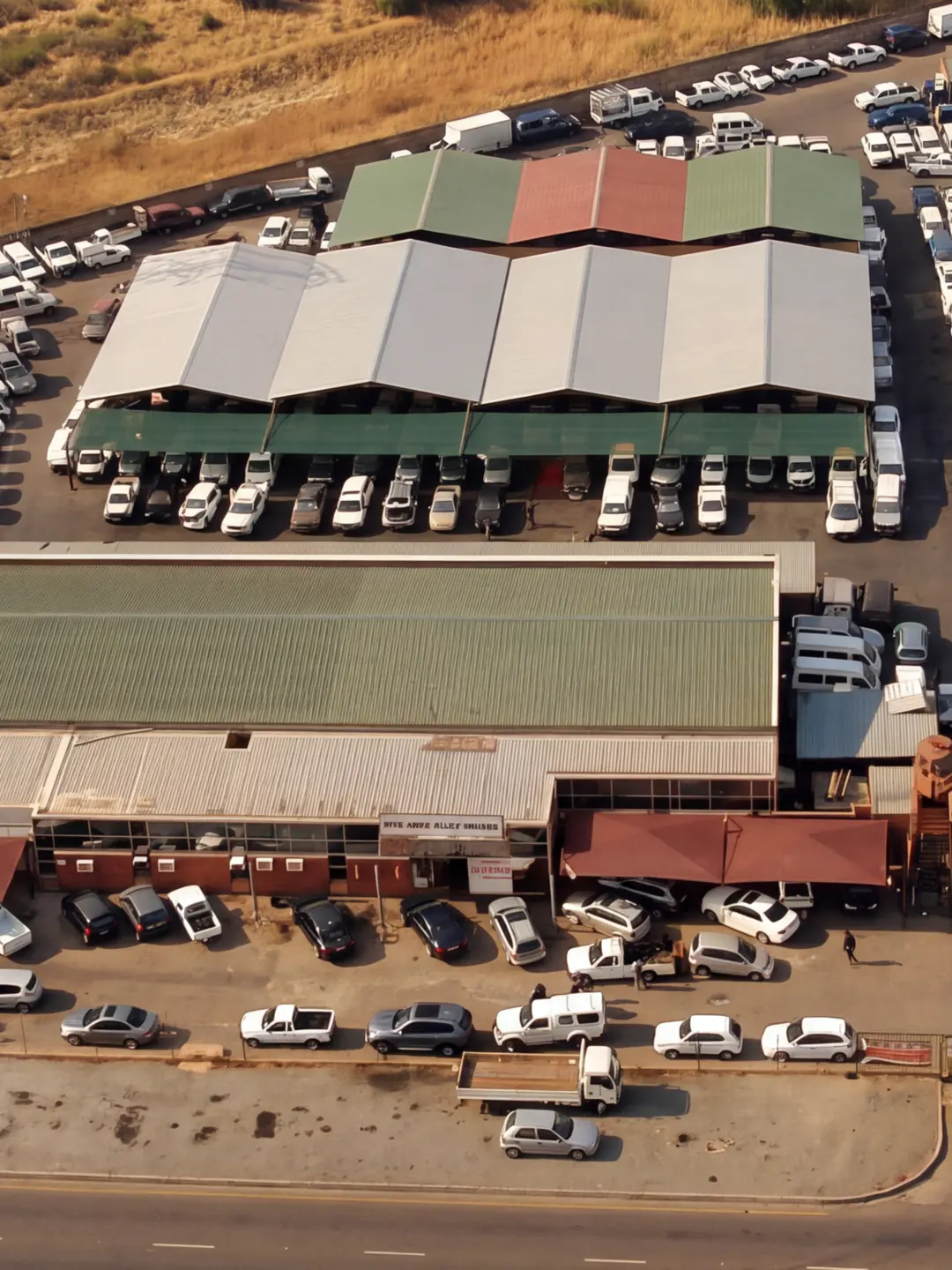 The City Deep Auto yard from above: covered bays and rows of vehicle stock